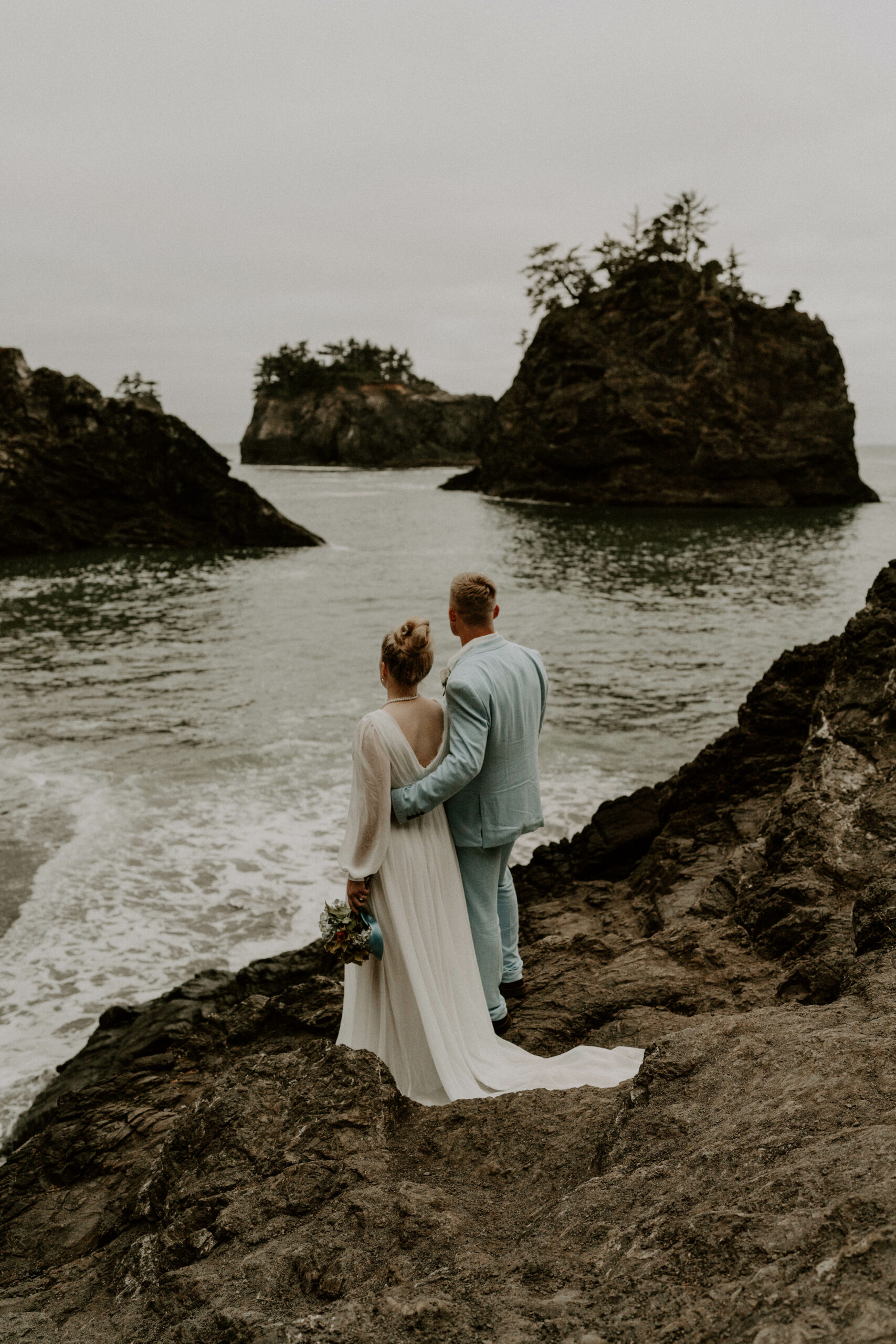 Bride and Groom Looking At The Ocean